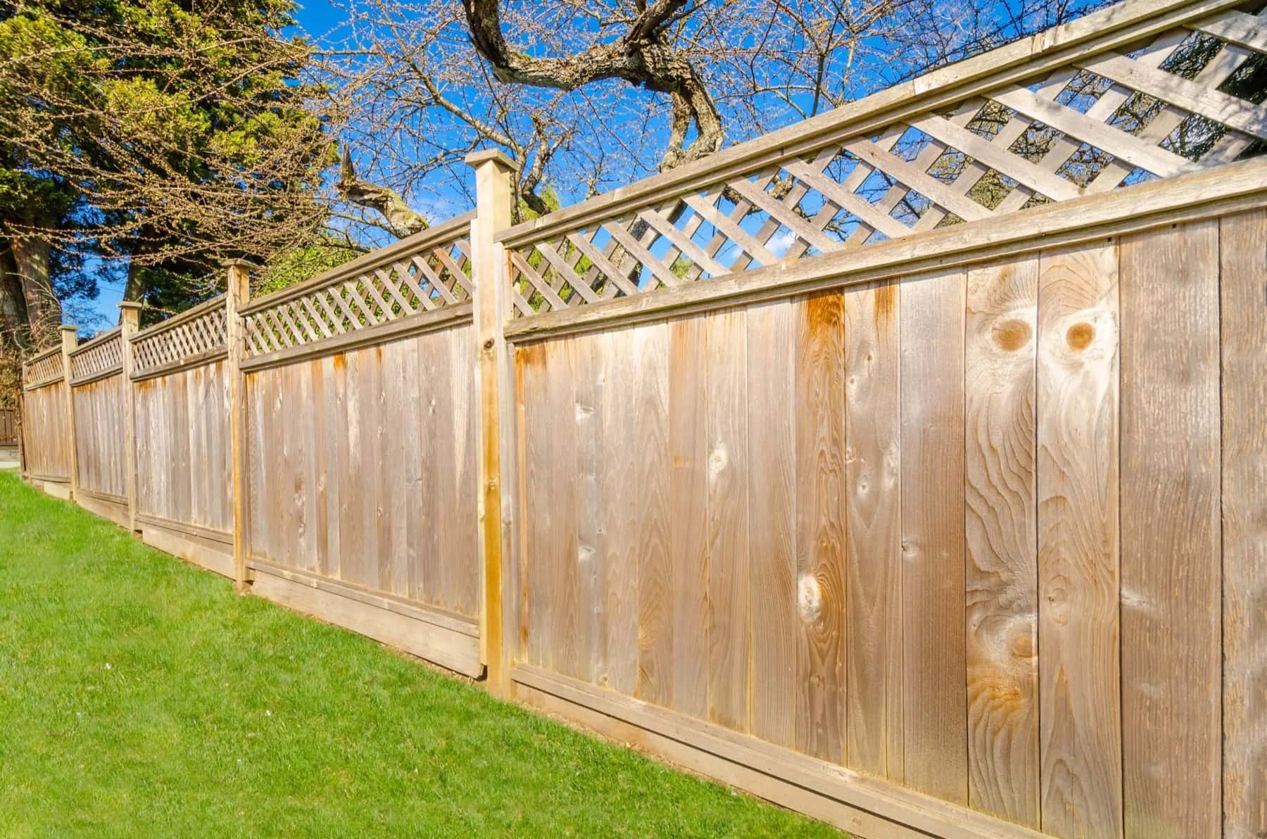 Fence installers working on a residential fence line