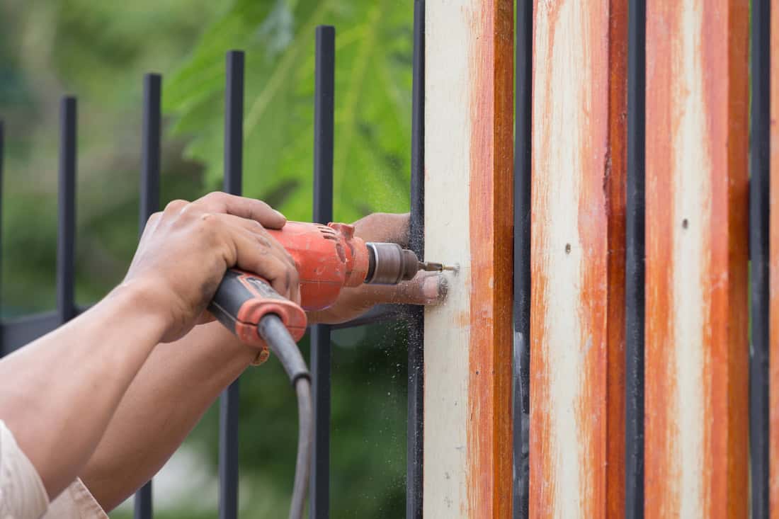Repaired wood fencing along a residential lot