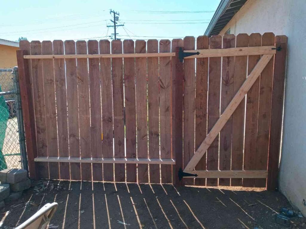 Wood fence and braced gate in a back yard