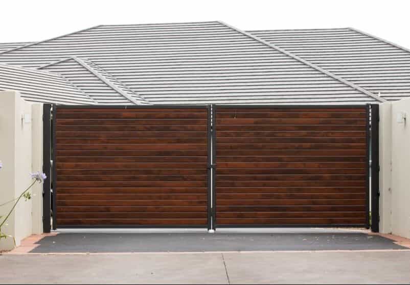 Wide RV gate beside a home, matched to the fence line
